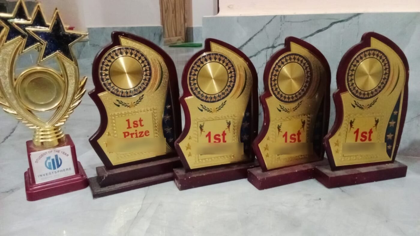 A row of first-place trophies and a Student of the Year award won by the foundation's first sponsored student.